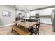 Open kitchen with a large island, white cabinets, and tile backsplash at 14616 Rocky Brook Dr, Tampa, FL 33625