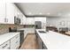 Modern kitchen with white cabinets, stainless steel appliances, and a stylish backsplash design at 14616 Rocky Brook Dr, Tampa, FL 33625