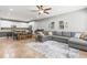 Open floor plan showcasing the kitchen, dining area, and a spacious living room with a comfortable gray sectional sofa at 14616 Rocky Brook Dr, Tampa, FL 33625