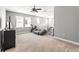 Spacious loft area with carpet flooring, plenty of natural light, and a modern ceiling fan at 14616 Rocky Brook Dr, Tampa, FL 33625