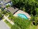 Overhead perspective of a community pool bordered by lounge chairs and vibrant greenery at 14616 Rocky Brook Dr, Tampa, FL 33625