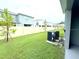 Lawn extending into the backyard with trees and a privacy fence, providing a quiet outdoor retreat at 1490 Colt Creek Pl, Wesley Chapel, FL 33543
