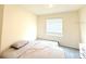 Bedroom with a large window allowing natural light with a bed and dresser at 1490 Colt Creek Pl, Wesley Chapel, FL 33543