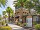 Beautiful clubhouse features a stone facade, mature landscaping, and community amenities sign at 1490 Colt Creek Pl, Wesley Chapel, FL 33543