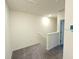 Upstairs hallway with neutral carpet leading to bedrooms and other living spaces at 1490 Colt Creek Pl, Wesley Chapel, FL 33543