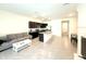 Bright open-concept living room and kitchen space with tile flooring and modern finishes at 1490 Colt Creek Pl, Wesley Chapel, FL 33543