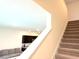 Staircase connects living area on the left, to the upstairs bedrooms with carpeted steps at 1490 Colt Creek Pl, Wesley Chapel, FL 33543