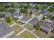 Aerial view of a residential neighborhood featuring well-maintained homes and green spaces on a sunny day at 15430 Long Cypress Dr, Ruskin, FL 33573