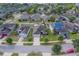 Aerial view of a neighborhood with well-maintained homes and green lawns, showcasing community living at 15430 Long Cypress Dr, Ruskin, FL 33573