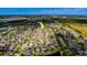 High aerial view of residential area near lakes and wooded areas, arrow points to property location at 15430 Long Cypress Dr, Ruskin, FL 33573