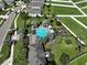 Aerial view of community pool, playground, and well-manicured lawns highlighting outdoor amenities at 15430 Long Cypress Dr, Ruskin, FL 33573
