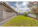 Backyard featuring an enclosed patio and well-maintained lawn at 15430 Long Cypress Dr, Ruskin, FL 33573