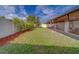 Nice backyard with healthy lawn, garden beds and enclosed patio at 15430 Long Cypress Dr, Ruskin, FL 33573