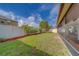 Spacious backyard featuring well-maintained lawn and white vinyl fence at 15430 Long Cypress Dr, Ruskin, FL 33573