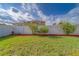 Fenced backyard with healthy green grass and mulch at 15430 Long Cypress Dr, Ruskin, FL 33573