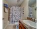 Cozy bathroom featuring a shower/tub combo and wooden vanity with granite countertops at 15430 Long Cypress Dr, Ruskin, FL 33573