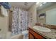 Cozy bathroom with a shower/tub combo and vanity with granite countertops at 15430 Long Cypress Dr, Ruskin, FL 33573