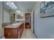 Spacious bathroom with double sinks, a shower and a door to the bedroom at 15430 Long Cypress Dr, Ruskin, FL 33573