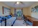 Inviting bedroom featuring a daybed, desk, and neutral walls, creating a comfortable and functional space at 15430 Long Cypress Dr, Ruskin, FL 33573