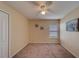 This bedroom features neutral walls, carpet, and a ceiling fan for comfortable living at 15430 Long Cypress Dr, Ruskin, FL 33573