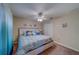 Charming bedroom features coastal decor, ceiling fan, and a large window at 15430 Long Cypress Dr, Ruskin, FL 33573