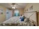 Comfortable bedroom featuring coastal accents, a ceiling fan, and natural light at 15430 Long Cypress Dr, Ruskin, FL 33573