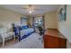 Inviting bedroom featuring a daybed, desk, and neutral walls, creating a comfortable and functional space at 15430 Long Cypress Dr, Ruskin, FL 33573