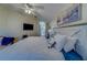 Relaxing bedroom featuring a ceiling fan, wood floors, and coastal decor at 15430 Long Cypress Dr, Ruskin, FL 33573