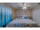 Cozy bedroom features coastal decor, ceiling fan, and a serene ambiance at 15430 Long Cypress Dr, Ruskin, FL 33573