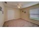 Bright bedroom with carpet, ceiling fan, and a large closet at 15430 Long Cypress Dr, Ruskin, FL 33573