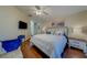 Comfortable bedroom with a ceiling fan, wood flooring, and ample natural light at 15430 Long Cypress Dr, Ruskin, FL 33573