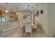 Stylish dining room with tiled floors, an elegant light fixture, and a dining set for comfortable meals at 15430 Long Cypress Dr, Ruskin, FL 33573