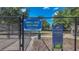 A dog park inside of a black chainlink fence has signage with the words, 'Small Dog Dog Park' at 15430 Long Cypress Dr, Ruskin, FL 33573