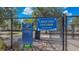 A dog park inside of a black chainlink fence has signage with the words, 'Large Dog Dog Park' at 15430 Long Cypress Dr, Ruskin, FL 33573