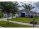 Charming single-story home with a well-kept lawn, inviting landscaping, and a serene neighborhood feel at 15430 Long Cypress Dr, Ruskin, FL 33573