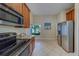 Spacious kitchen featuring stainless steel appliances, granite countertops, and tile flooring at 15430 Long Cypress Dr, Ruskin, FL 33573