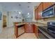 Functional kitchen with stainless steel appliances and granite countertops, perfect for culinary enthusiasts at 15430 Long Cypress Dr, Ruskin, FL 33573