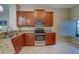 Well-lit kitchen featuring stainless steel appliances, granite countertops, and ample cabinet space at 15430 Long Cypress Dr, Ruskin, FL 33573