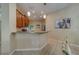 Open kitchen area boasts granite countertops, pendant lighting, and ample cabinet space for modern convenience at 15430 Long Cypress Dr, Ruskin, FL 33573