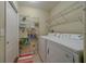 Functional laundry room featuring a washer, dryer, and ample shelving for storage and organization at 15430 Long Cypress Dr, Ruskin, FL 33573