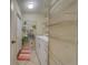 Convenient laundry room featuring a washer, dryer, and wire shelving for optimal storage solutions at 15430 Long Cypress Dr, Ruskin, FL 33573
