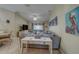 Bright living room with a sectional sofa, coastal artwork, and a glimpse of the dining area at 15430 Long Cypress Dr, Ruskin, FL 33573