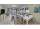 Comfortable living room with a large sectional sofa, neutral decor, and sliding glass doors to the outdoors at 15430 Long Cypress Dr, Ruskin, FL 33573