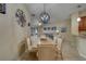 Dining room featuring an ornate chandelier and wall decor, transitioning into the cozy living area at 15430 Long Cypress Dr, Ruskin, FL 33573