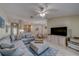 Open-concept living space with a sectional sofa, kitchen view, and dining area for seamless entertaining at 15430 Long Cypress Dr, Ruskin, FL 33573