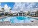 Community pool with shade structure and lounge seating, perfect for relaxation and socializing at 15430 Long Cypress Dr, Ruskin, FL 33573