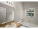 Bathroom features a shower-tub combo, vanity, and window for natural light at 16119 Bridgedale Dr, Lithia, FL 33547