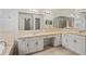 Bathroom vanity with double sinks, large mirrors, and ample counter space at 16119 Bridgedale Dr, Lithia, FL 33547