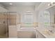 Bathroom featuring separate shower, soaking tub, and a large window at 16119 Bridgedale Dr, Lithia, FL 33547