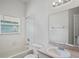 Bathroom with a shower-tub combo and a vanity sink with a mirror at 16119 Bridgedale Dr, Lithia, FL 33547
